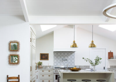 kitchen with white walls and warm gray cabinets and artistic geometric tile