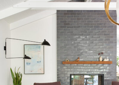 high white wood beam ceilings with gray brick fireplace