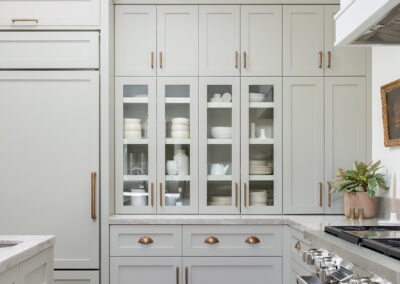 kitchen with soft gray cabinets and copper fixtures