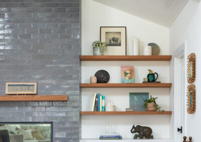 built in modern shelving and gray brick fireplace