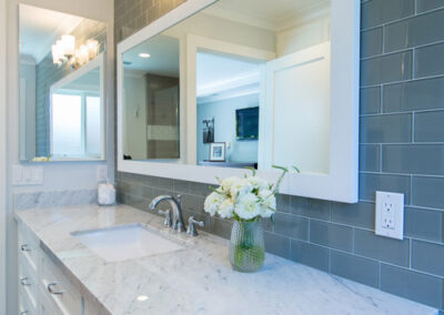 white marble countertops and gray glass tile bathroom