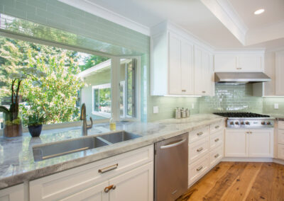 kitchen with white cabinets and sea foam green tile