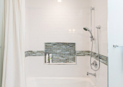 white tub with tile surround