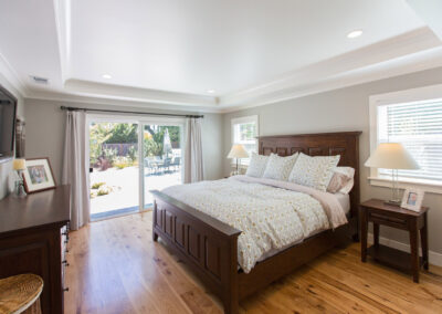 master bedroom with recessed ceiling and beautiful hardwood floors