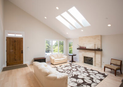 vaulted ceiling with skylight in a spacious living room
