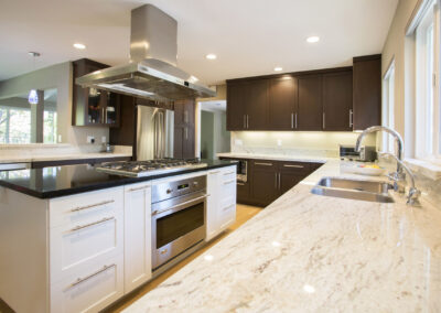 kitchen with white granite countertops and a mix of dark wood and white cabinetry