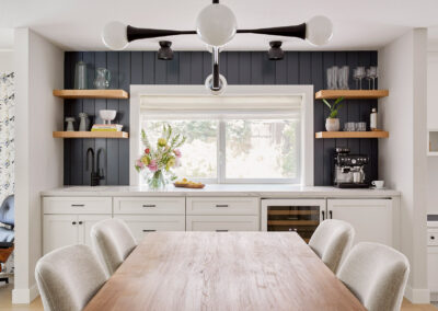 dining room with wet bar built in cabinetry and modern light fixture