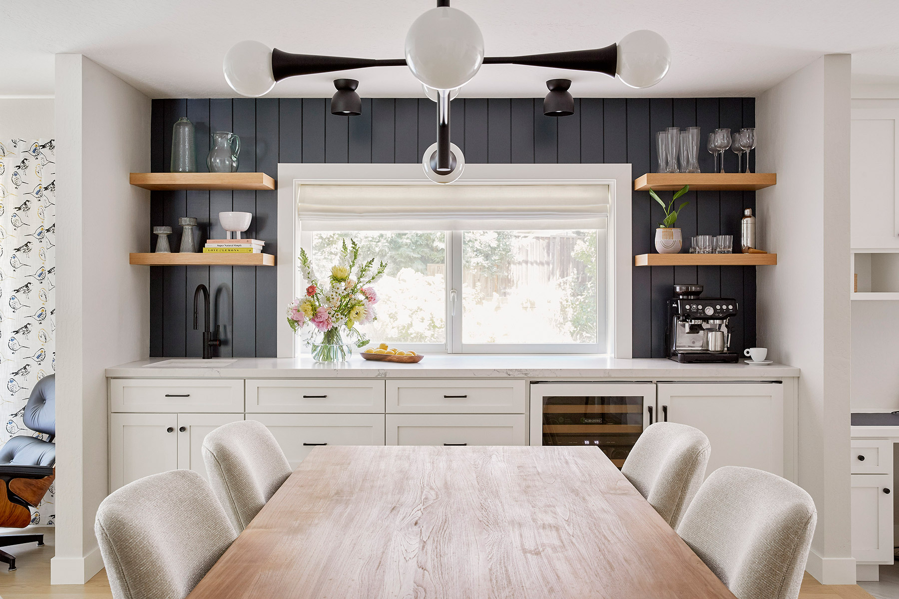 dining room with wet bar built in cabinetry and modern light fixture