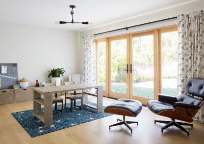 den home office with glass doors and modern light fixture