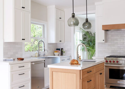 light and bright kitchen with white walls and white cabinets on light wood floors