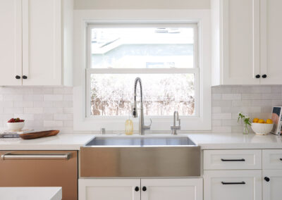 stainless steel farmhouse sink in kitchen