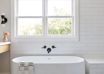 master bathroom with white soaker tub and gray slate tile floors