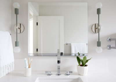 bathroom with modern sconce lights and modern chrome fixtures