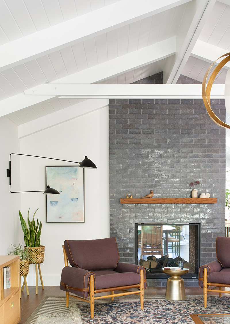 modern living room with glossy gray brick fireplace and high ceilings