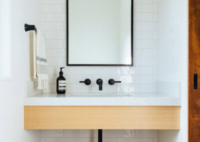 powder room sink and modern shelving and white subway tile wall