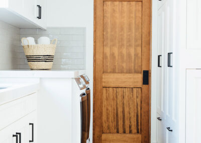 laundry room with spanish tile floor and rustic wooden door