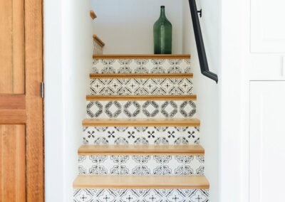 staircase with black and white artistic tile on each step