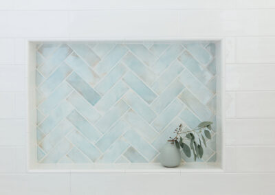aqua blue chevron pattern tile shower niche