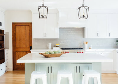 kitchen with bar stools and white cabinets and wooden rustic door