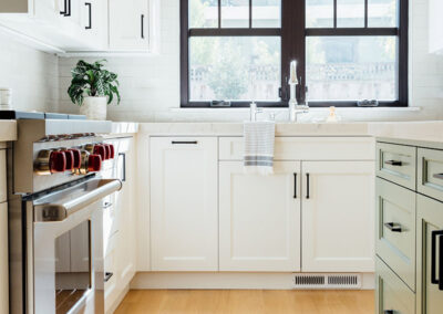 kitchen window with black frame and white tile wall